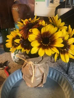 Sunflowers wrapped in brown paper and tied with twine