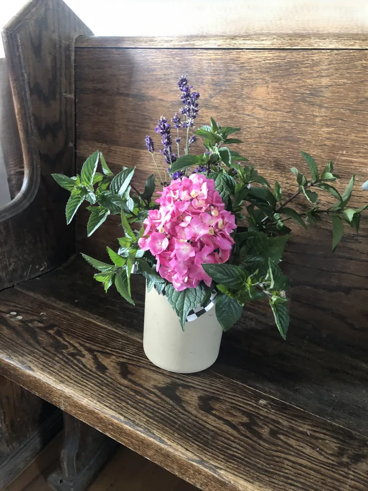 Cut flowers in a jug on barn board