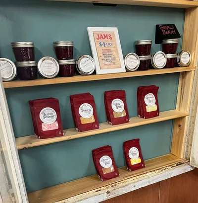 Rows of labelled preserve jars on wooden shelving