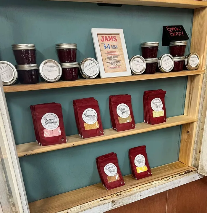 Rows of labelled preserve jars on wooden shelving
