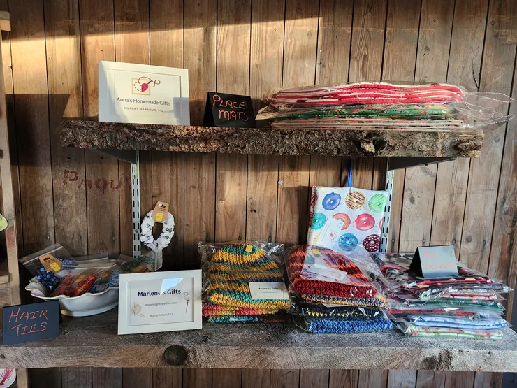 Anna's Homemade Gifts and Marlene's Gifts on the store shelves, with place mats, knitted hats and hair ties